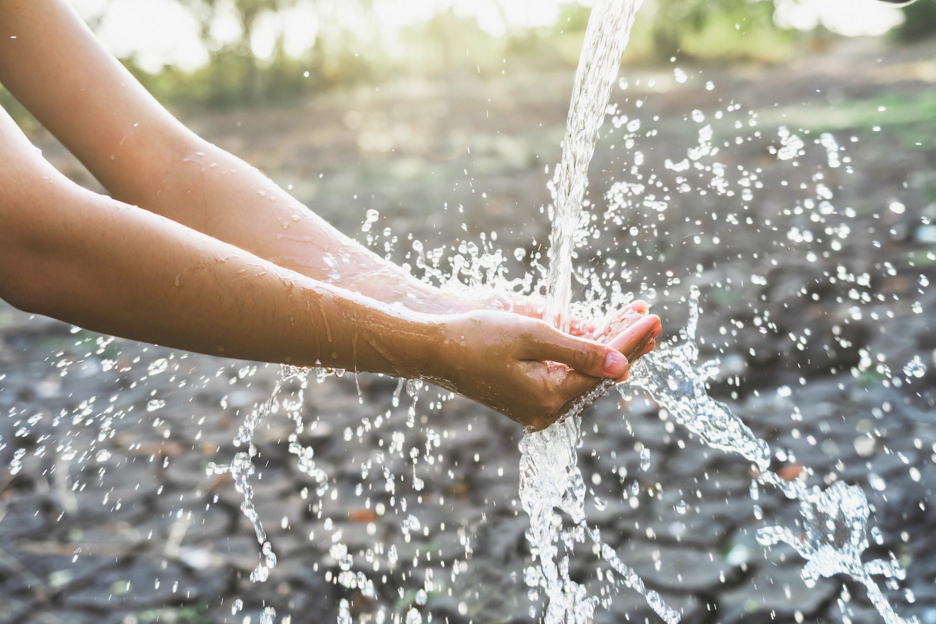 Hands catching clean flowing water