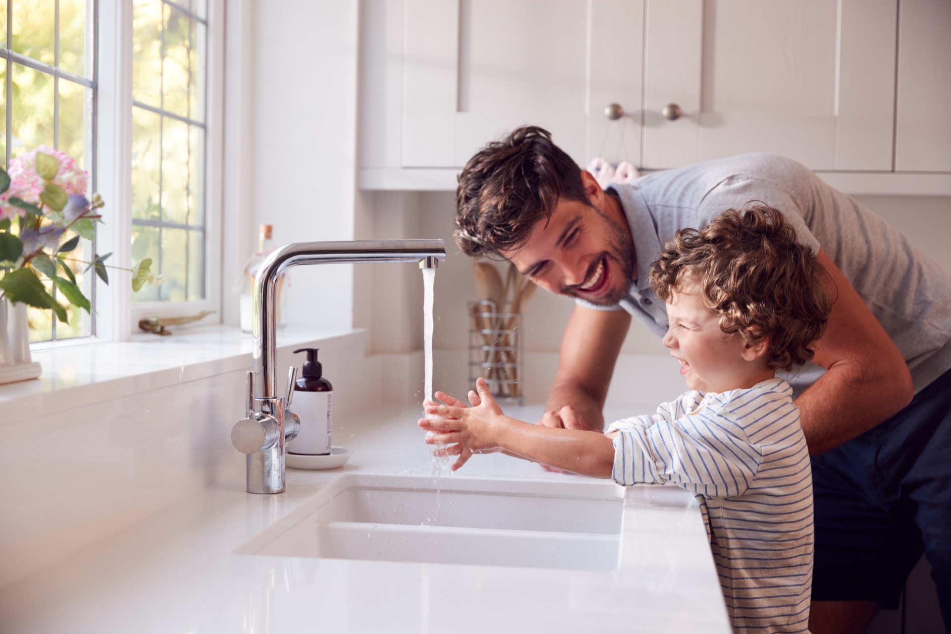 Father and son enjoying clean drinking water